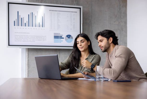 ANDBANC advisory team reviewing market research and portfolio charts